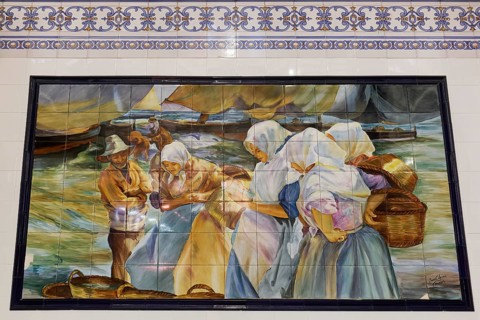 Fishermen and women by the sea