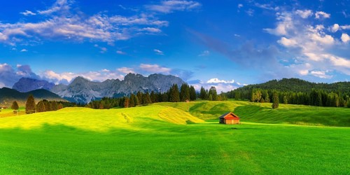 green meadows with cottage