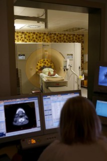 Doctor monitors patient on monitor at CT