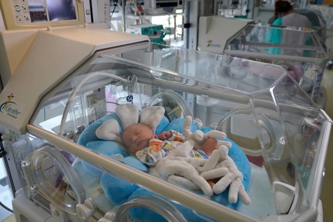 Newborn in incubator
