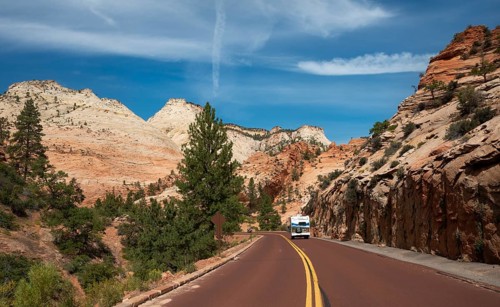 Caravan on road through mountain landscape