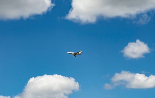 Business Jet flying in front of a blue cloudy sky