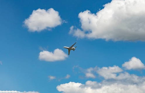 Business Jet flying in front of a blue cloudy sky