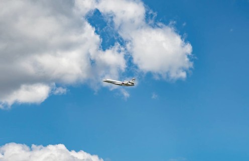 Business Jet flying in front of a blue cloudy sky