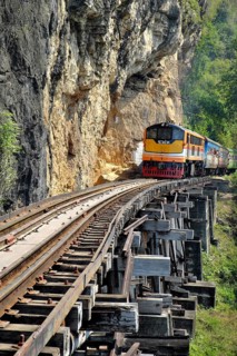Passenger train runs on wooden bridge