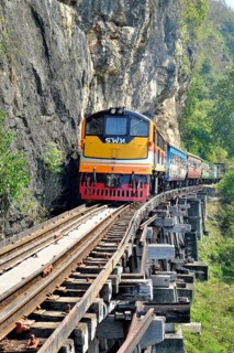 Passenger train runs on wooden bridge