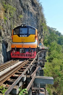 Passenger train runs on wooden bridge