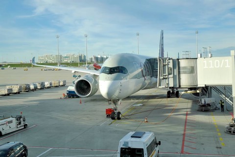 Airbus A350 with passenger boarding bridge
