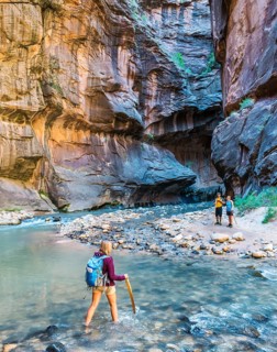 Hiker crossing river