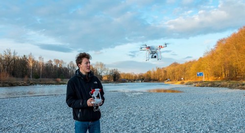 Young man controlling quadcopter