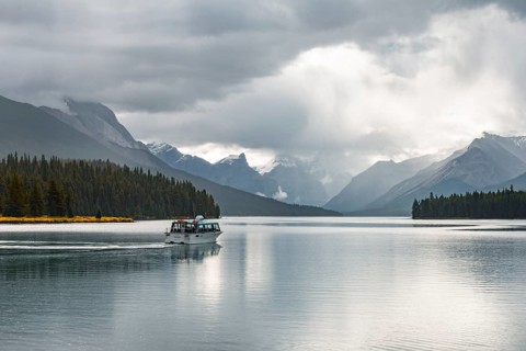 Excursion boat with tourists on Maligne Lake