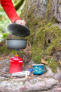 Steaming pot stands on camping stove
