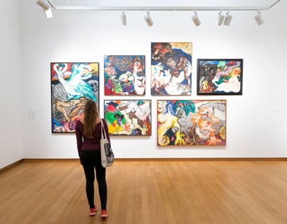 Visitor looks at modern paintings