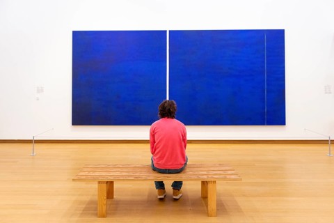 Visitor looks at modern painting