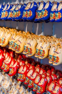 Traditionally colorfully painted Dutch wooden shoes on rack for sale