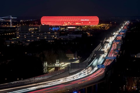 Red lit Allianz Arena at A9 motorway