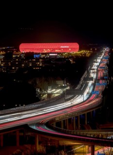Red lit Allianz Arena at A9 motorway