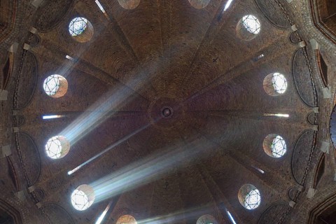 Rays of light shine through windows of the dome
