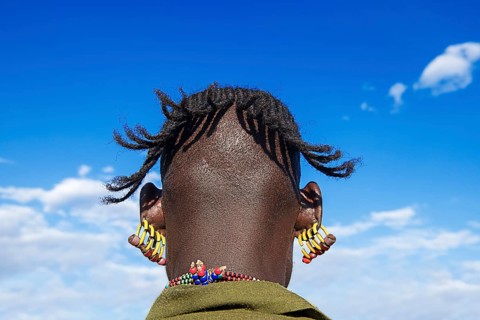 Man with four earrings in each ear