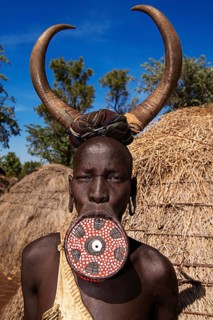 Woman with large lip plate and horns as headdress