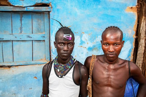 Young men of the Hamer ethnic group with colourful hair clips and pearl jewellery