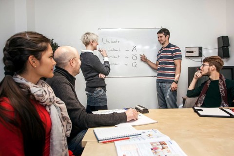 Group of adult students with a teacher