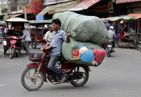 Man with moped and large sacks