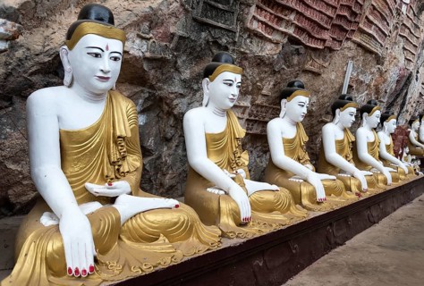 Line of Buddha statues at Kaw-goon Cave Temple