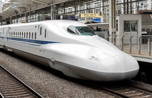 Shinkansen bullet train arriving to railway station