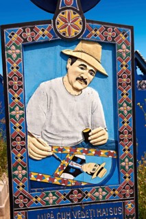 Tombstone showing a man painting the tombstones