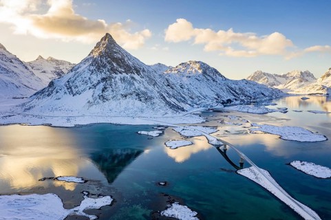 Mountain Volandstinden reflected in Fjord