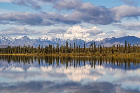 Snowy mountain Denali reflected in the lake with cloudy sky