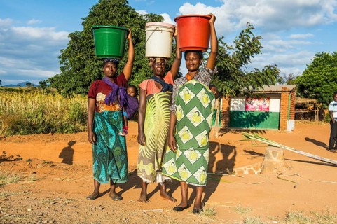 Local women carrying buckets on their head