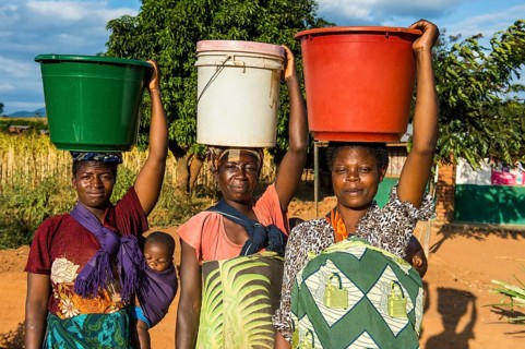 Local women carrying buckets on their head