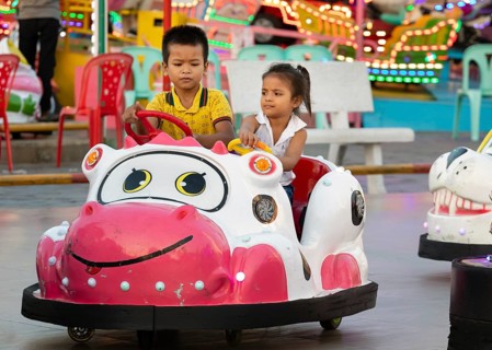 Children driving bumper cars in Koh Pich theme park