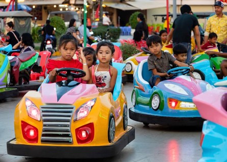 Children driving scooters at Koh Pich theme park