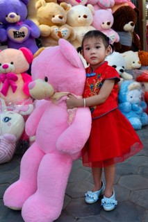 Little girl with big teddy bear in Koh Pich theme park