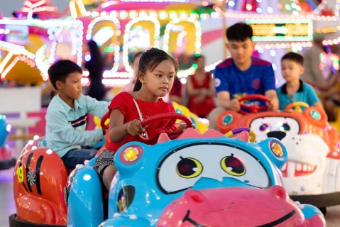 Children driving bumper cars at Koh Pich theme park