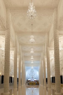 Ornamental columns in the white prayer hall with Buddha statue