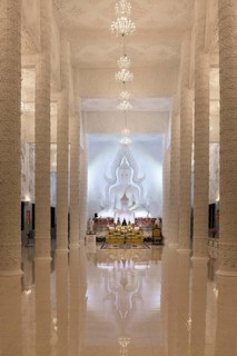 Ornamental columns in the white prayer hall with Buddha statue