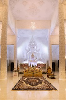 Ornamental columns in the white prayer hall with Buddha statue