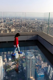 Little girl on the glass skywalk