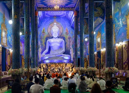 Believers in front of the Blue Buddha Statue of Wat Rong Seur Ten