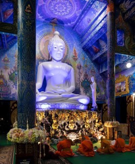 Monks in front of the blue Buddha statue of Wat Rong Seur Ten
