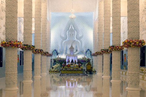 Ornamental columns in the white prayer hall with Buddha statue