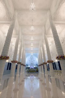 Ornamental columns in the white prayer hall with Buddha statue