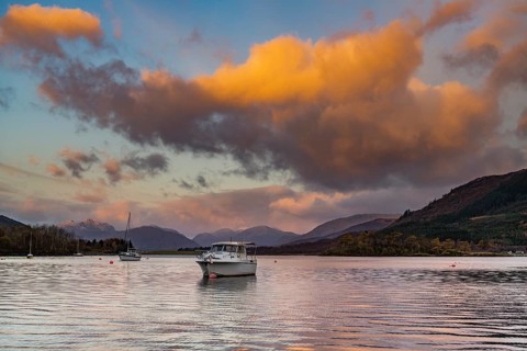 Boats with Loch Linnhe at sunrise with coloured clouds