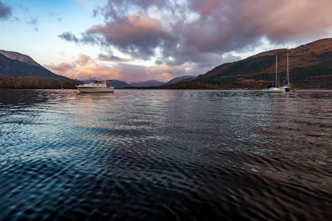 Boats with Loch Linnhe at sunrise with coloured clouds