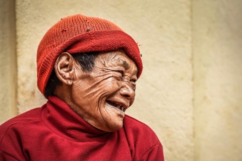 Laughing woman with cap