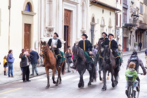 Participants in historical clothing riding on horses